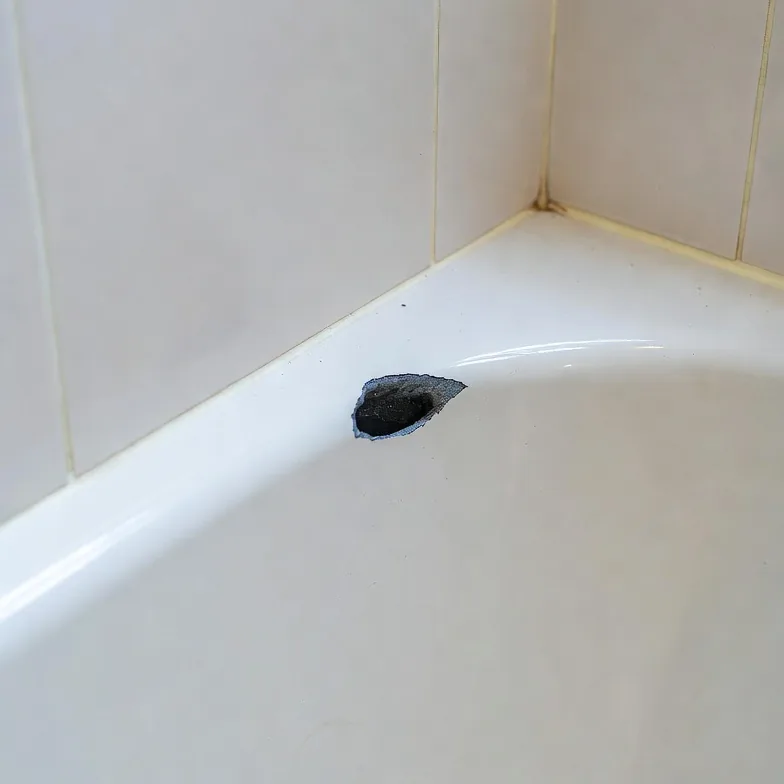 Before photo of a bathtub chip repair area