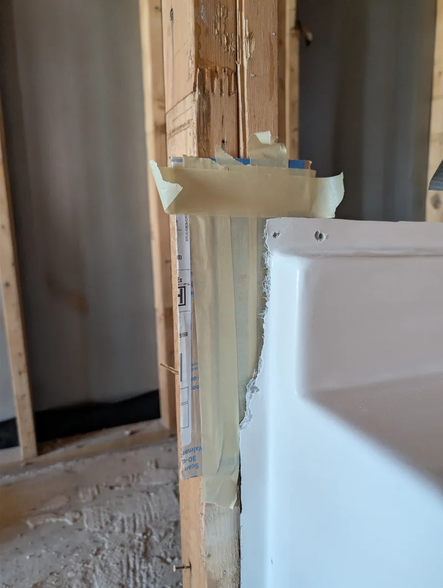 Broken fiberglass tub and shower corner flange before repair in Mesquite, Texas